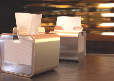 Dos unidades de dispensador servilletas mesa aluminio colocadas en una mesa de restaurante elegante con iluminación cálida de fondo.